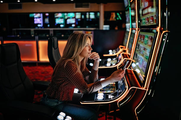 Women gambling on slot machinery